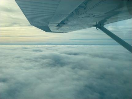 Flying over large patches of fog to get to clear skies.