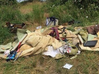 Pile of garbage dumped at water access site