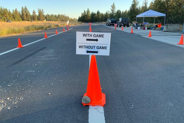 A sign saying to stop for chronic wasting disease testing