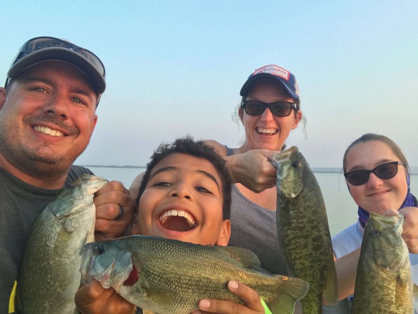 family fishing for bass, all smiles