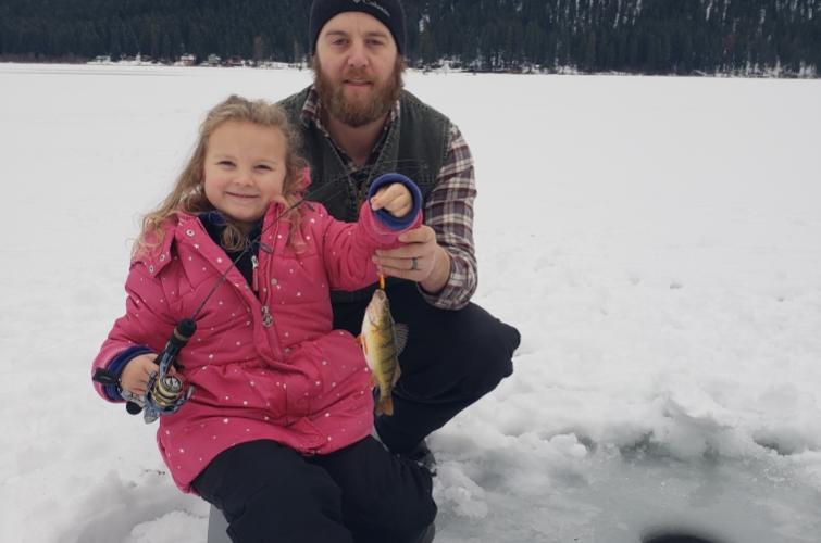 A girl and her dad ice fishing