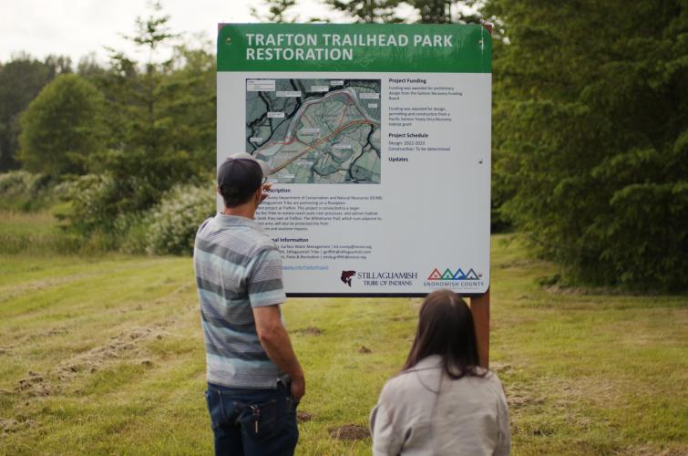 Viewing a sign at the Trafton Restoration Project site on the Stillaguamish River near Arlington.