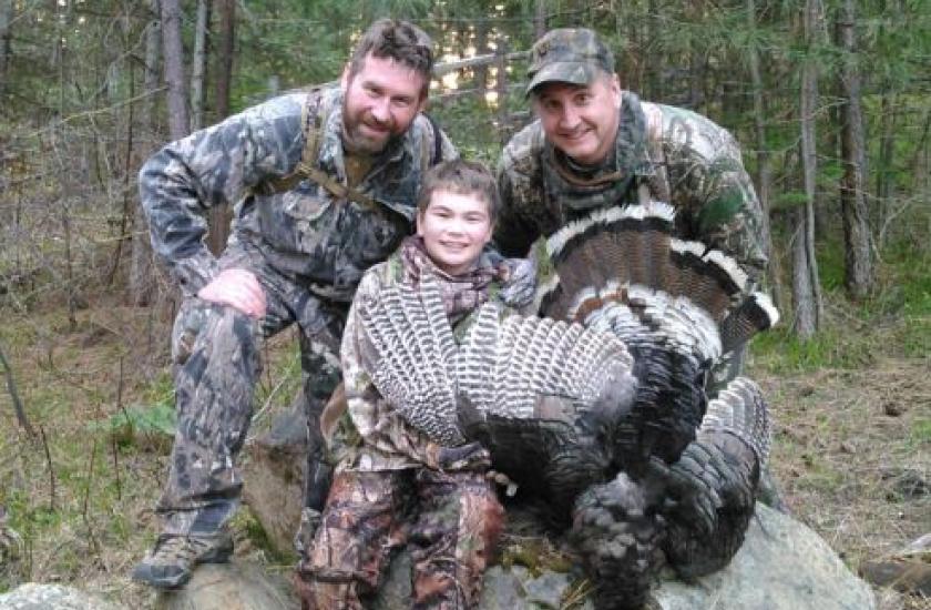 Rich Mann posing for a photo with Aaron Garcia and Aaron's son Mitchell after successfully harvesting a turkey.