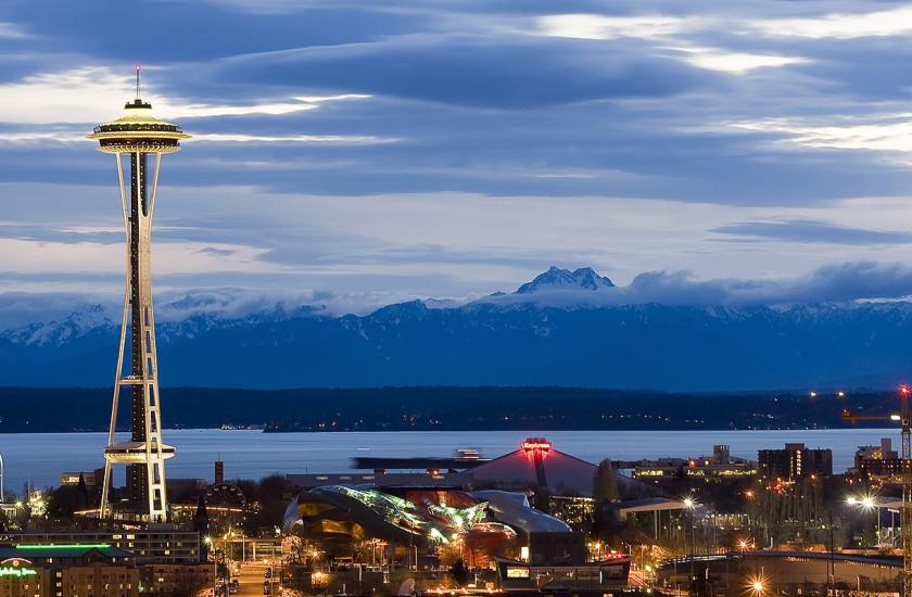 Olympic Mountains, Puget Sound and Seattle Center as night falls. Photo by Jeffery Hayes