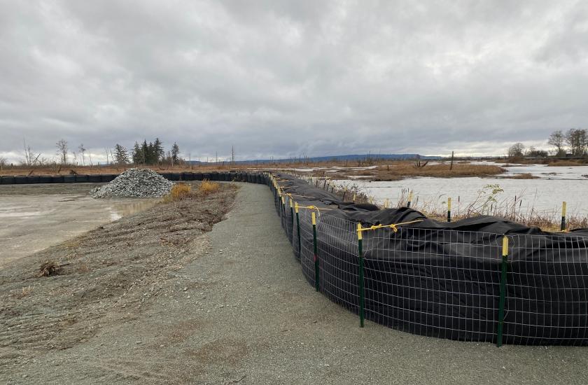The temporary flood barrier, staged construction materials, and soft surfaces at Skagit Headquarters Unit in Dec. 2023