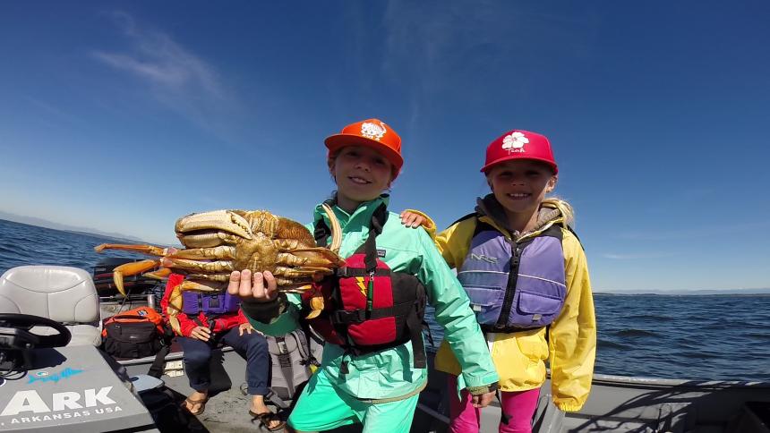 two girls with crab in puget sound