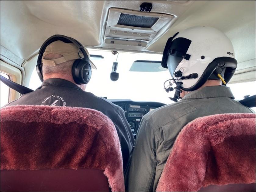 Pilot LaDow and Biologist Fidorra enjoying the red, fuzzy seat-covers of the Cessna.