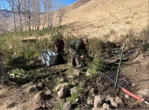 The trough being installed in Ladybug Canyon.