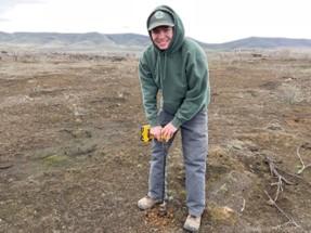 Natural Resource Technician Cardenas planting sagebrush with hand drill auger.