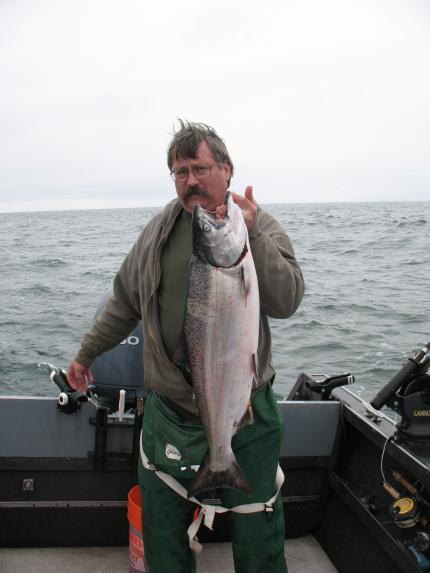 Angler holds Chinook salmon caught off Washington coast