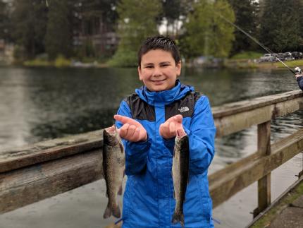 Boy holds trout caught on opening day