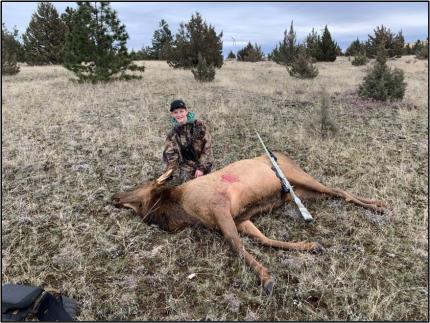 A youth hunter with his elk