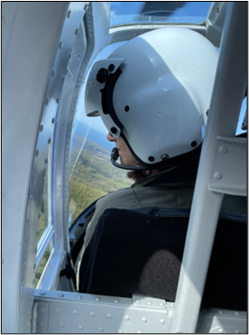 Biologist Cent look to her left in a helicopter.