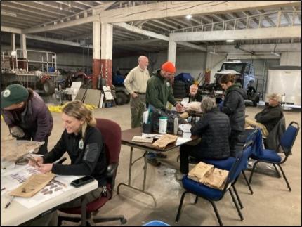 Biologists around a table examining feathers