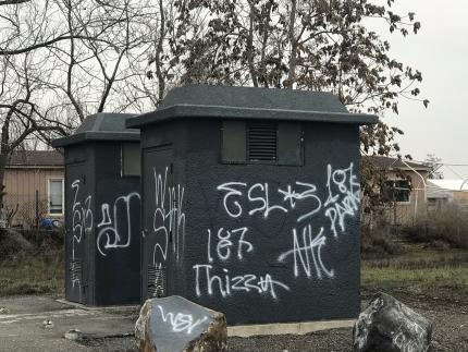 Two structures tagged with graffiti
