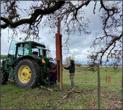 Breitenstein operating a post driver.