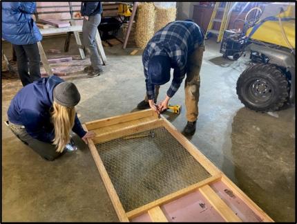 A crew securing final pieces to a floating trap