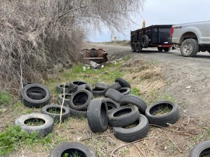 Discarded tires off the side of the road.