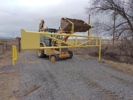 Lowering the new gate into place.