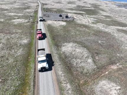 A overhead view of three trucks on the Swanson Lakes entry road.