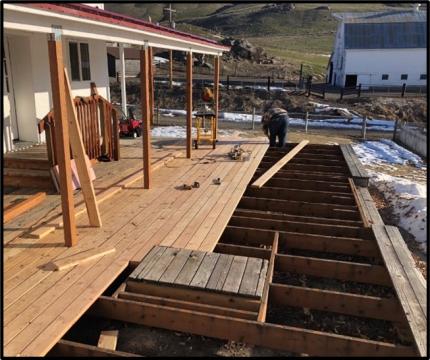 Staff replacing the four posts and deck boards at the Scotch Creek office.