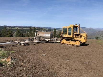 A farm cat with a 50 inch sprayer.