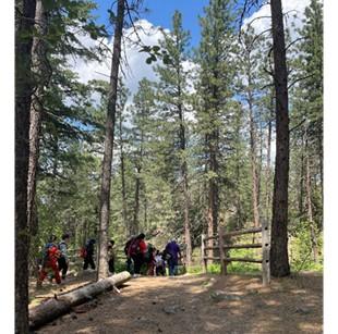 Students in the woods being led by a WDFW instructor