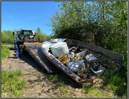 An abandoned boat being removed.