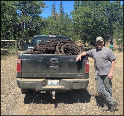 Master Hunter Volunteer Rudberg with a truck full of barbed wire