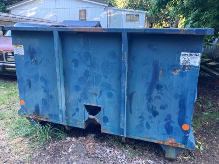 A dumpster with bear paw prints on the front of it