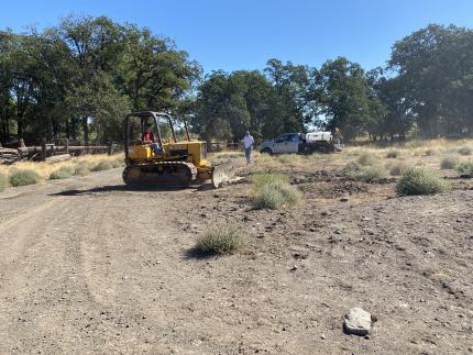 A tractor leveling an area