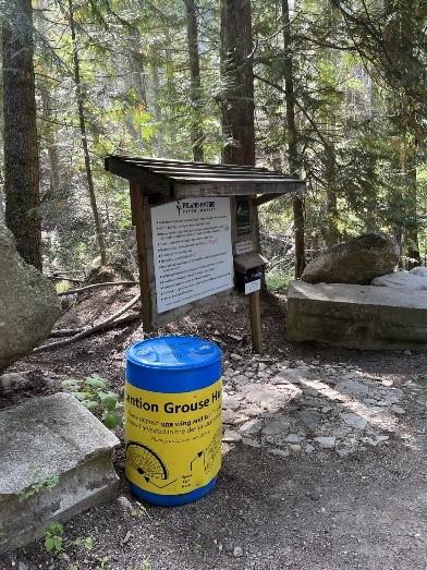 A grouse barrel next to a sign