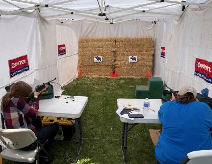 A mother and daughter practicing safe firearm handling