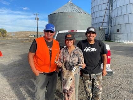 Hunters showing their recently harvested white-tail deer. 