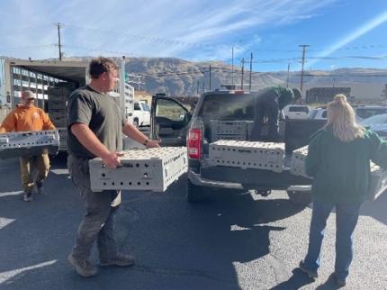 Team members from the Wenatchee district office loading up the work trucks. 