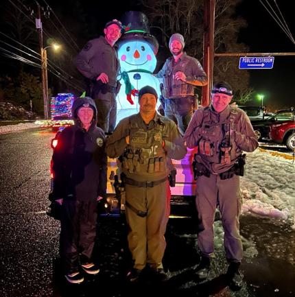 Biologist Bergh and two Detachment 53 staff members at the Starlight Parade in Stevenson.