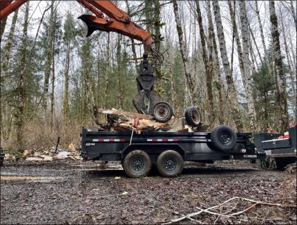 Abandoned RV being loaded into a trailer