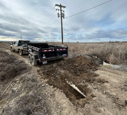 A truck and trailer filling a sink hole