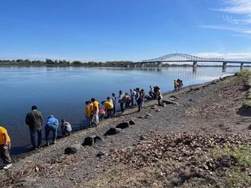 Students releasing salmon into the Columbia River.