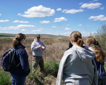 Biologist Cook discussing Desert Unit critters with students. 