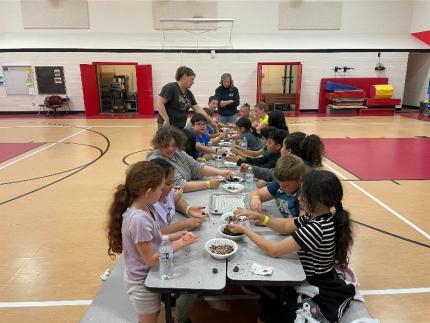 A group of Mesa Elementary students getting their hands dirty and crafting wildflower seedballs.