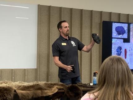 Biologist Brinkman discussing characteristics of bear tracks during a bear education presentation.