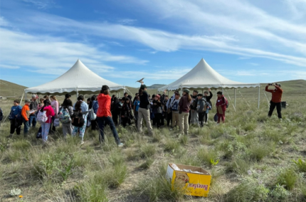 Biologists Blake and Haupt talking to elementary school students about sharp-tailed grouse. 