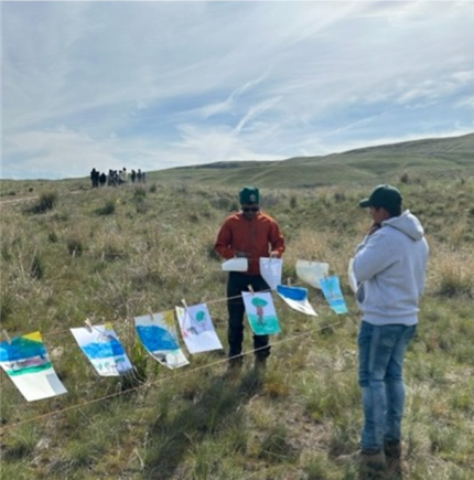 Natural Resource Tech. Haney-Williamson and Garcia hanging paintings during the STEAM by the STREAM event.