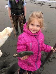 girl holding first razor clam