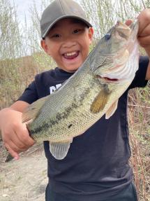 Boy holds largemouth bass