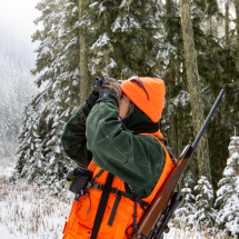 Hunter scans understory in search of elk in snowy setting
