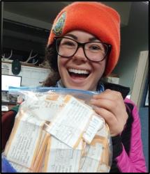 Staff member holding a bag of pygmy rabbit samples