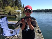 A boy holds a trout