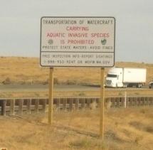 A sign on the highway saying it is illegal to transport aquatic invasive species